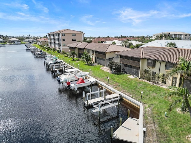 208 Lewis Cir Unit 4A, Punta Gorda, FL 33950 - dock featuring boat lift, a water view, a residential view, and a yard