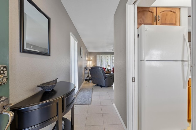 kitchen featuring white fridge and light tile patterned flooring