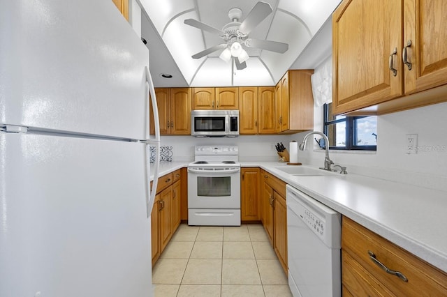 kitchen with white appliances, ceiling fan, sink, lofted ceiling, and light tile patterned flooring