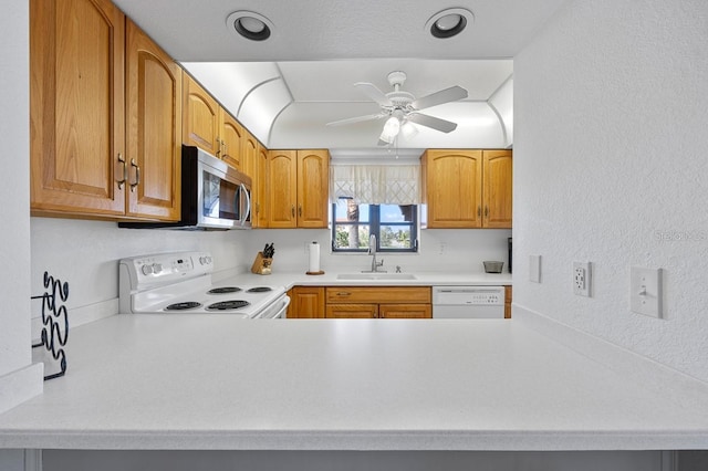 kitchen featuring ceiling fan, sink, and white appliances