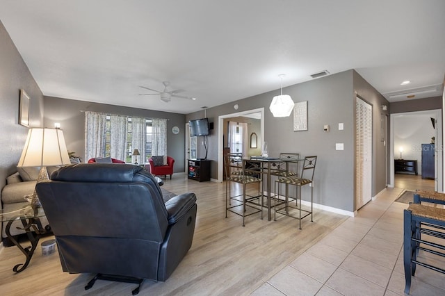 living room with ceiling fan and light hardwood / wood-style floors