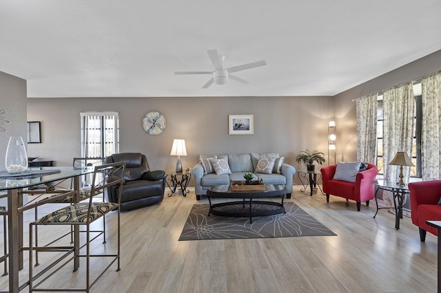 living room featuring ceiling fan and light wood-type flooring