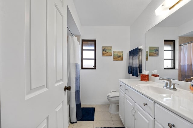 bathroom with tile patterned flooring, vanity, and toilet