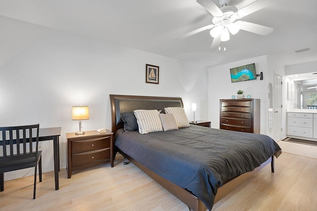 bedroom featuring ensuite bath, ceiling fan, and light hardwood / wood-style flooring