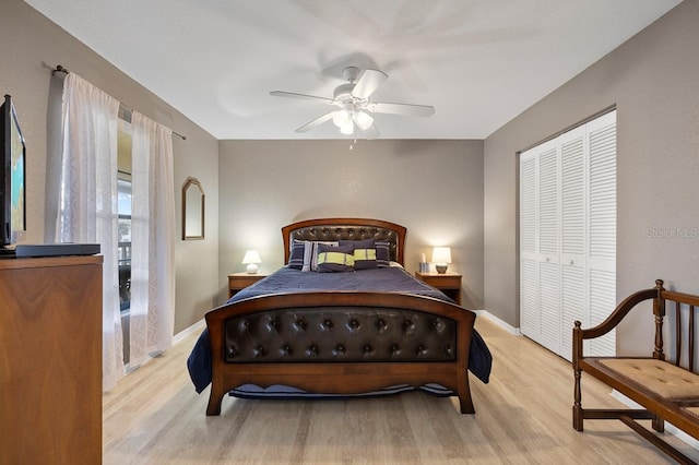 bedroom featuring ceiling fan, a closet, and light hardwood / wood-style flooring