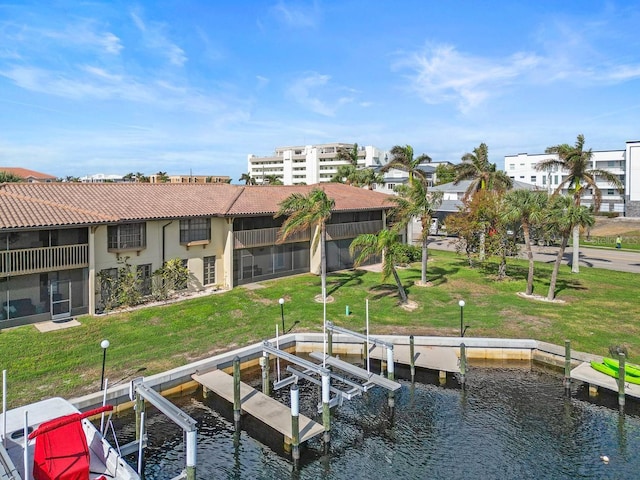 208 Lewis Cir Unit 4A, Punta Gorda, FL 33950 - dock featuring boat lift, a water view, and a lawn