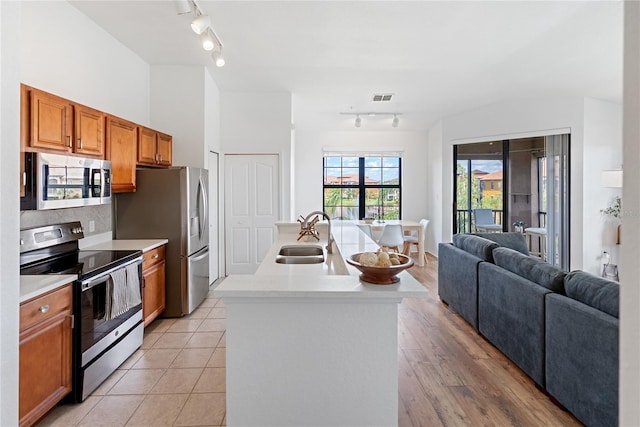 8377 38th Street Cir E Unit 308, Sarasota, FL 34243 - kitchen featuring appliances with stainless steel finishes, track lighting, a sink, and light countertops