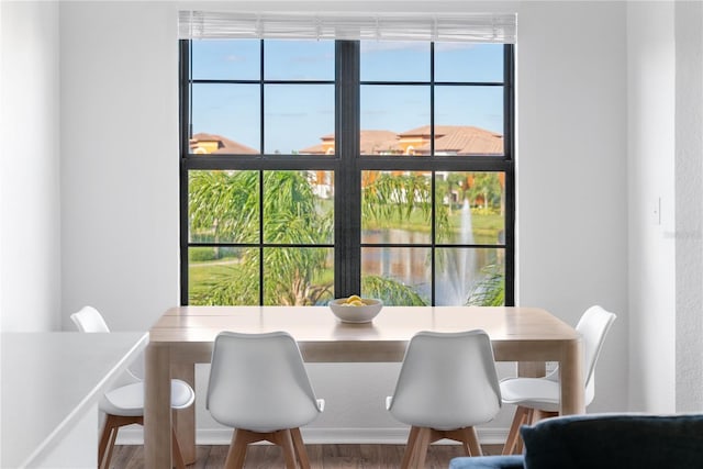 8377 38th Street Cir E Unit 308, Sarasota, FL 34243 - dining space with wood finished floors, a water view, and healthy amount of natural light