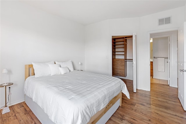 8377 38th Street Cir E Unit 308, Sarasota, FL 34243 - bedroom with wood finished floors, baseboards, and a closet