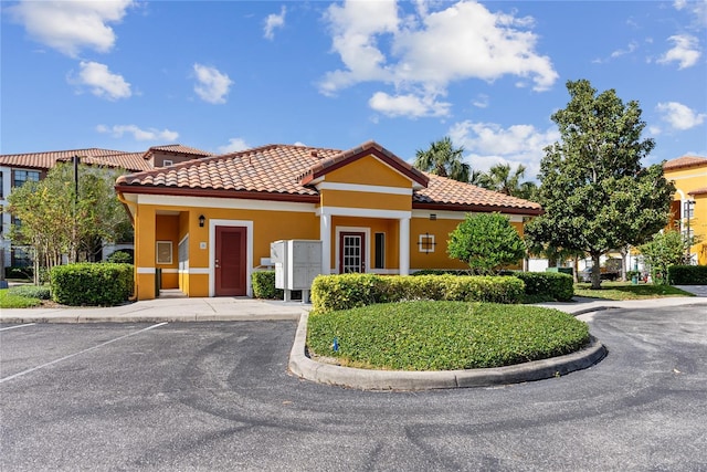 8377 38th Street Cir E Unit 308, Sarasota, FL 34243 - view of front of home featuring stucco siding, uncovered parking, and a tile roof