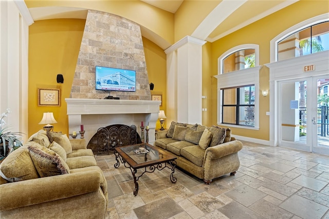 8377 38th Street Cir E Unit 308, Sarasota, FL 34243 - living area with stone tile floors, plenty of natural light, a high ceiling, a fireplace, and arched walkways