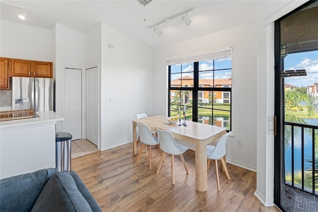 8377 38th Street Cir E Unit 308, Sarasota, FL 34243 - dining room with track lighting, light wood-style flooring, and baseboards