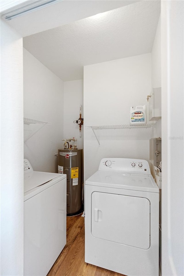 8377 38th Street Cir E Unit 308, Sarasota, FL 34243 - laundry area featuring electric water heater, independent washer and dryer, and light wood-style floors