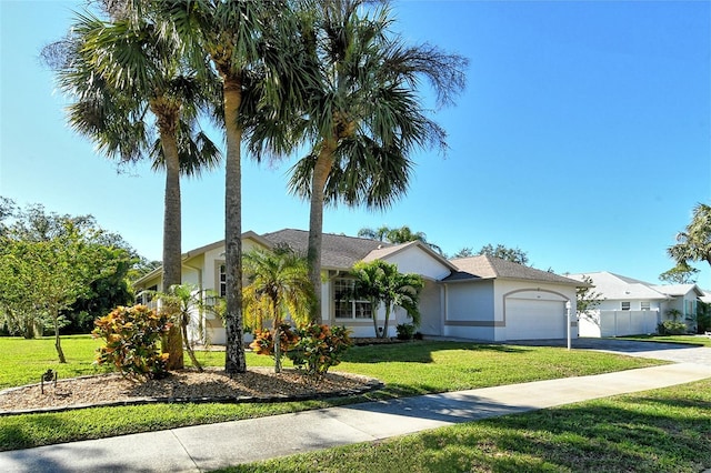 single story home featuring a garage and a front lawn