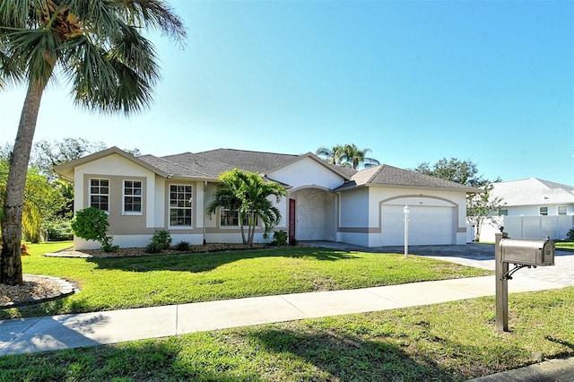 ranch-style house featuring a garage and a front lawn