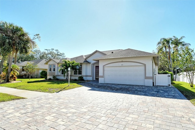 ranch-style house featuring a front lawn and a garage