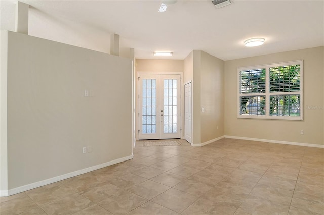 tiled spare room with french doors