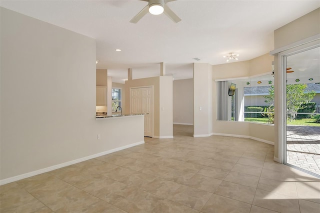 empty room featuring light tile patterned floors and ceiling fan