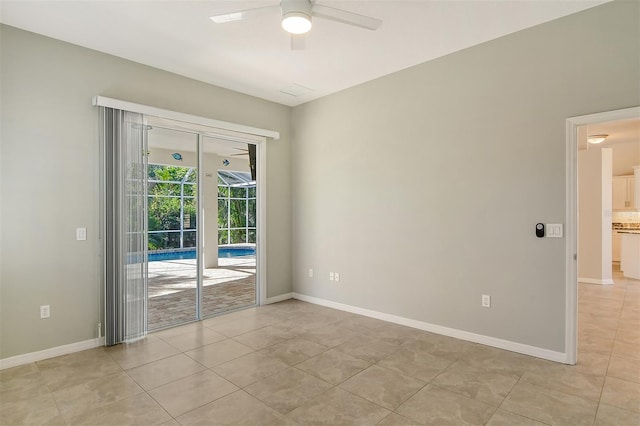 tiled empty room with ceiling fan