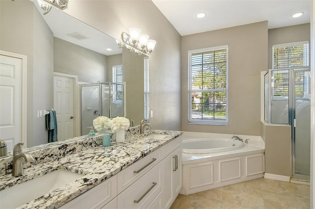 bathroom featuring tile patterned flooring, vanity, and shower with separate bathtub