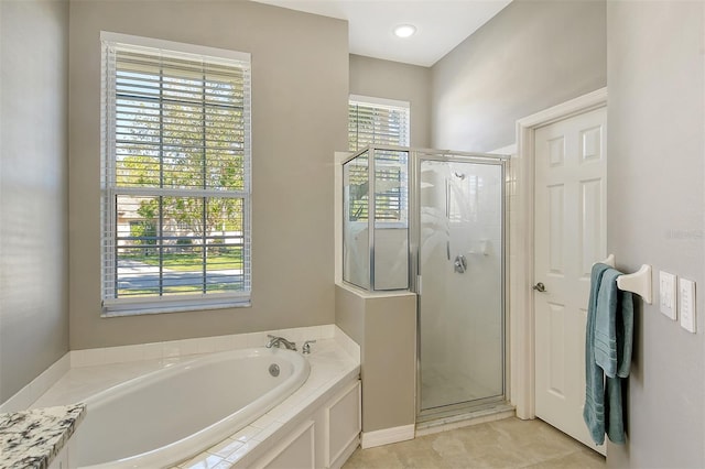 bathroom with tile patterned floors and independent shower and bath