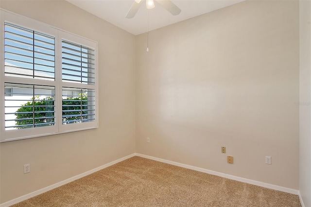 carpeted empty room featuring ceiling fan