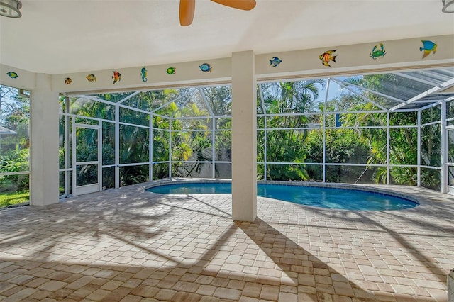 view of pool with a patio, ceiling fan, and a lanai