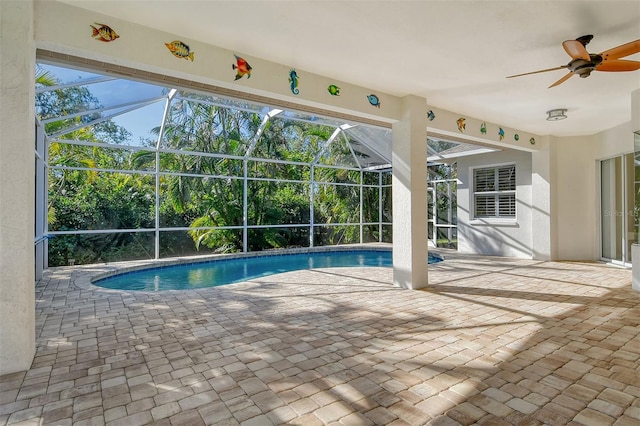 view of pool with a patio, ceiling fan, and a lanai