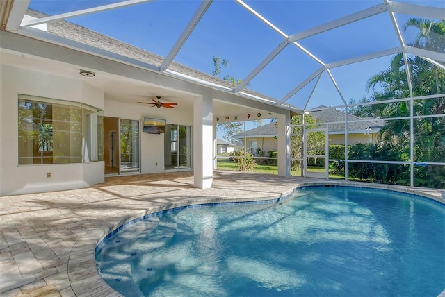 view of swimming pool featuring a lanai, ceiling fan, and a patio