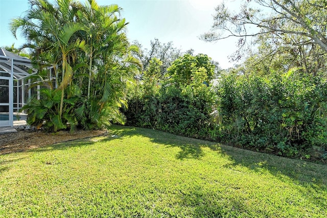 view of yard featuring a lanai