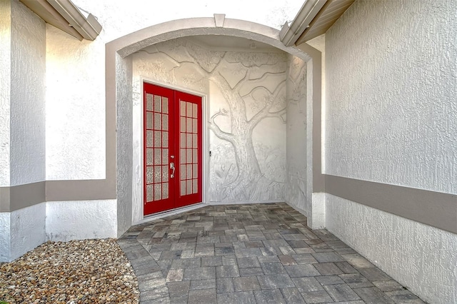 view of exterior entry featuring french doors