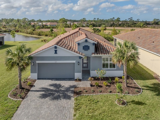 view of front of home featuring a water view, a front yard, and a garage