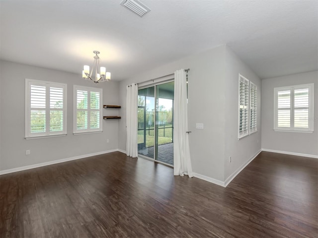 empty room featuring dark hardwood / wood-style flooring and a wealth of natural light