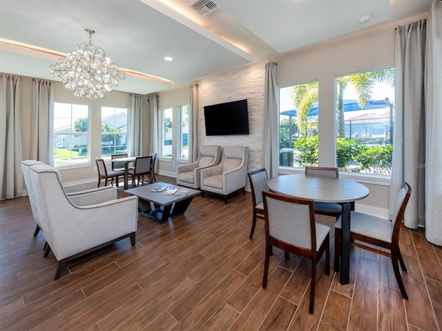 living room with hardwood / wood-style floors and a chandelier