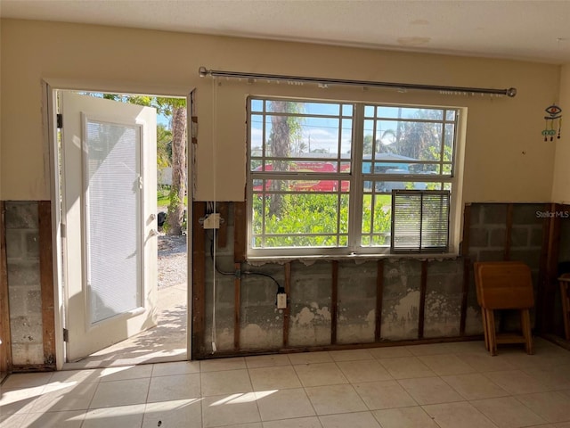 miscellaneous room with light tile patterned flooring and a healthy amount of sunlight