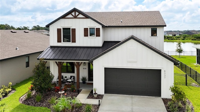 modern inspired farmhouse featuring a water view, a garage, a porch, and a front yard