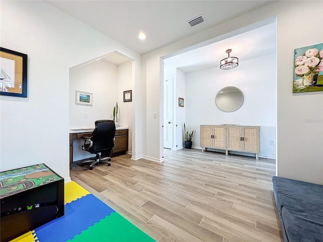 office space with light hardwood / wood-style flooring