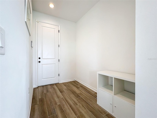 corridor featuring dark wood-type flooring