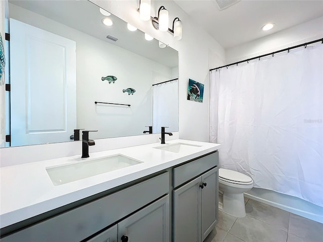 full bathroom featuring vanity, toilet, shower / bath combo with shower curtain, and tile patterned flooring