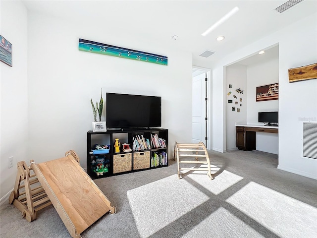 carpeted living room with built in desk