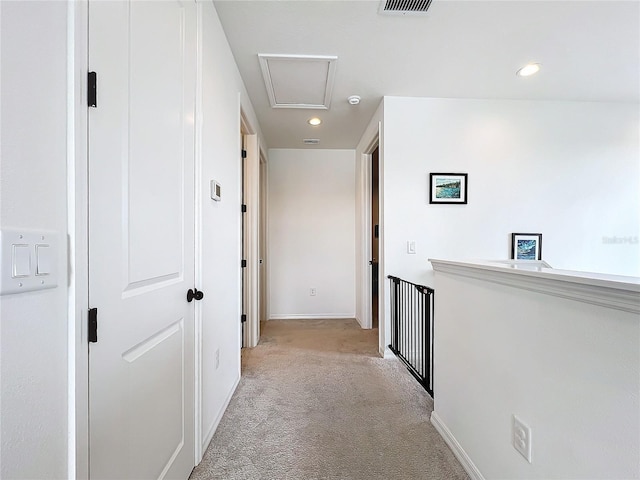 hall featuring light colored carpet