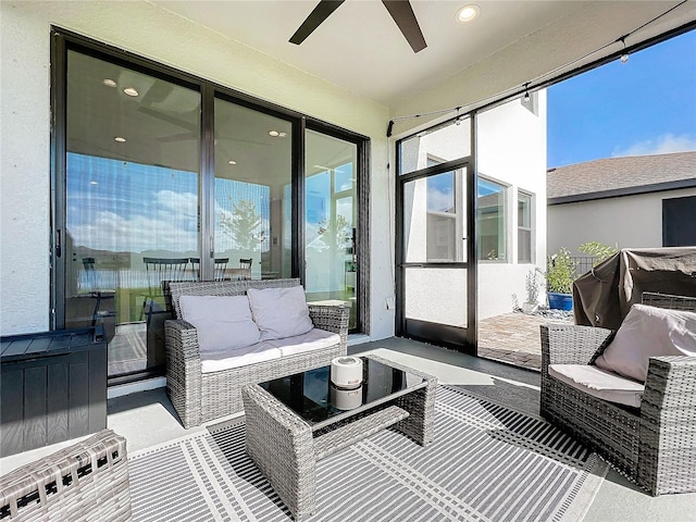 sunroom featuring ceiling fan