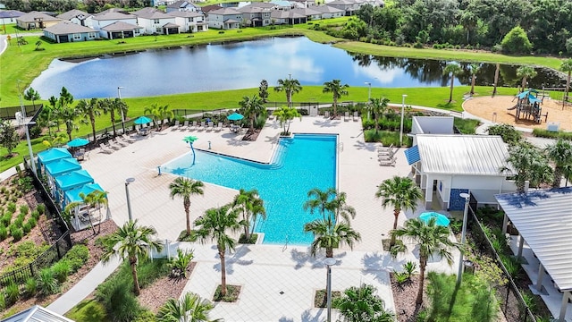 view of swimming pool with a patio and a water view