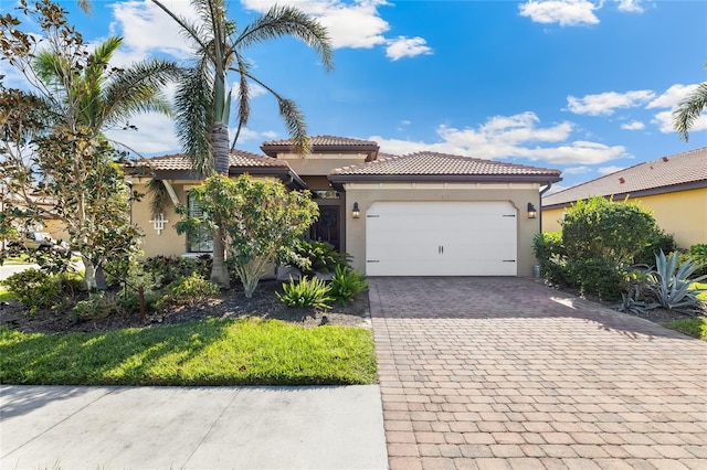 mediterranean / spanish-style home with a garage