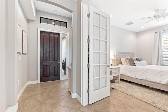 bedroom with ceiling fan and light tile patterned floors