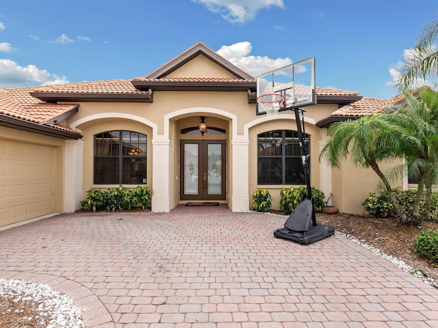 doorway to property featuring french doors and a garage