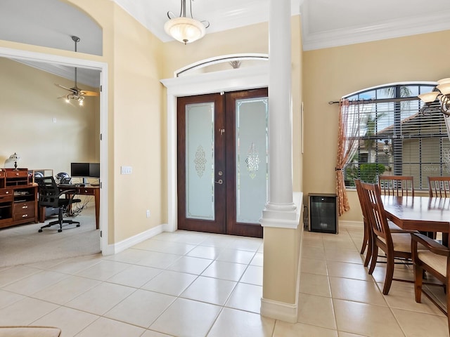 entryway featuring ceiling fan, french doors, light tile patterned floors, and decorative columns