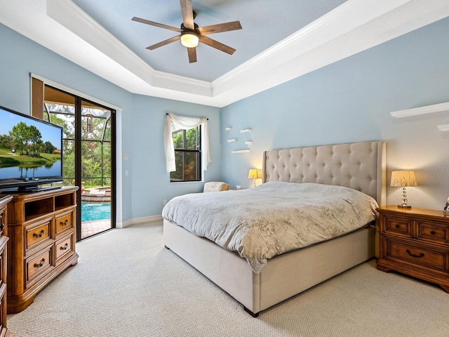 bedroom with a raised ceiling, access to exterior, ceiling fan, and light colored carpet