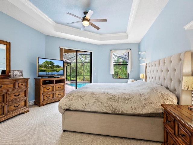 bedroom with access to outside, ceiling fan, a tray ceiling, and light carpet