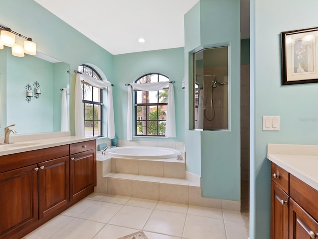 bathroom featuring tile patterned floors, vanity, and independent shower and bath